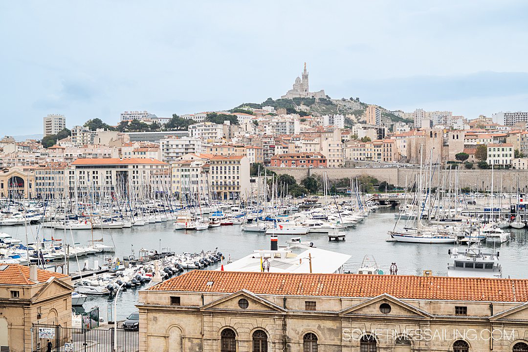 View of the old port, Vieux Port, in Marseille with Notre Dame de la Garde basilica in the distance on the hill.