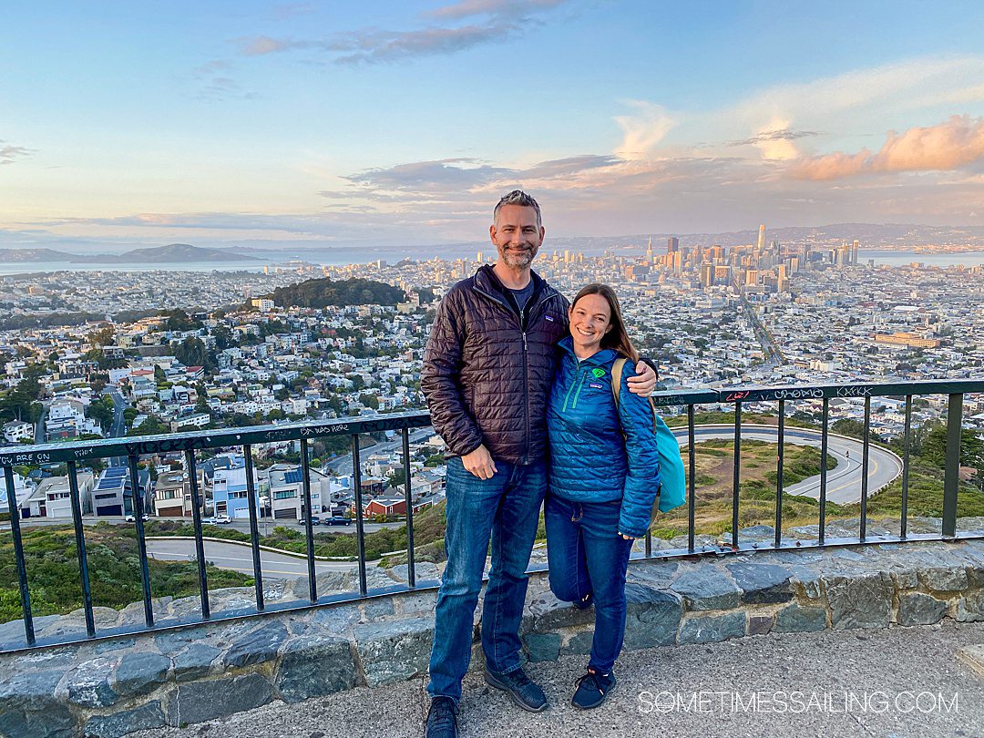 Couple with an aerial view of San Francisco behind them during sunset during a California Princess cruise.