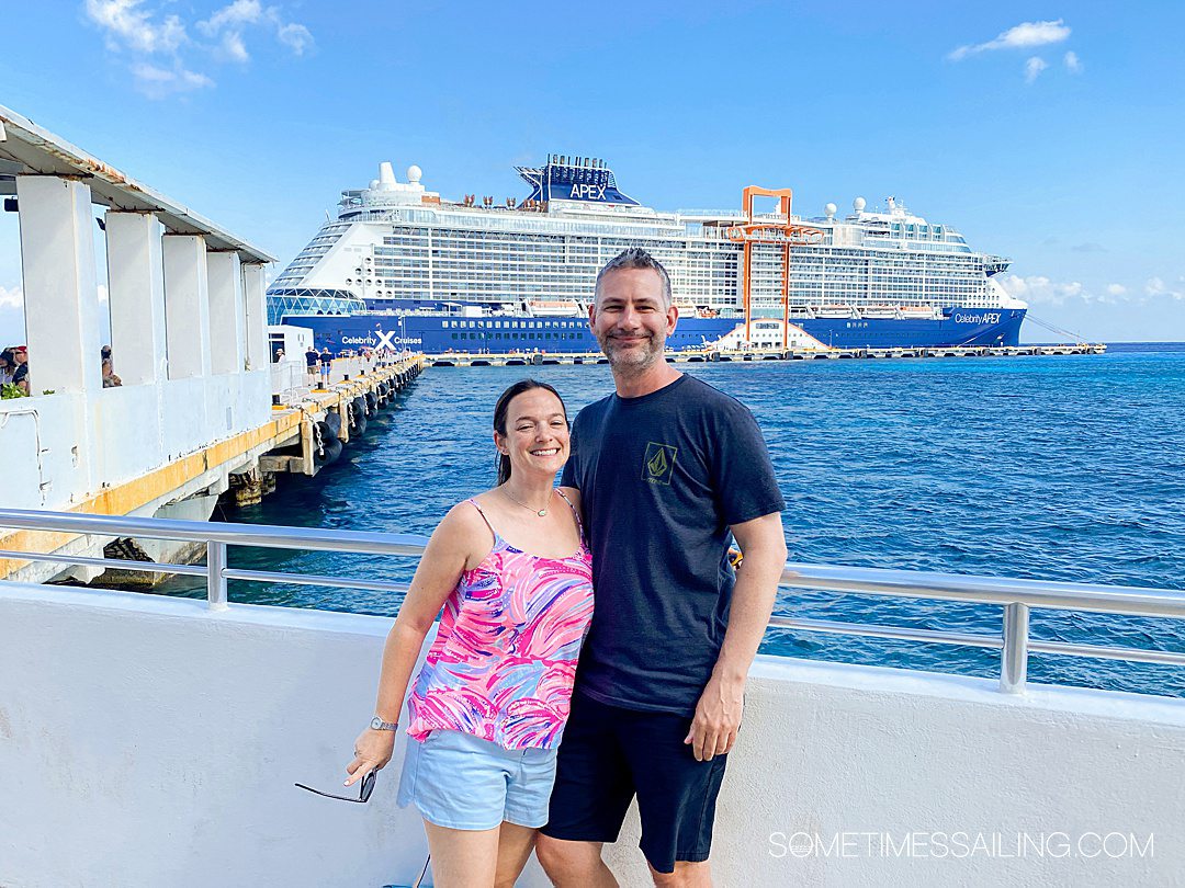 Couple in front of Celebrity Cruises Apex cruise ship in the distance.