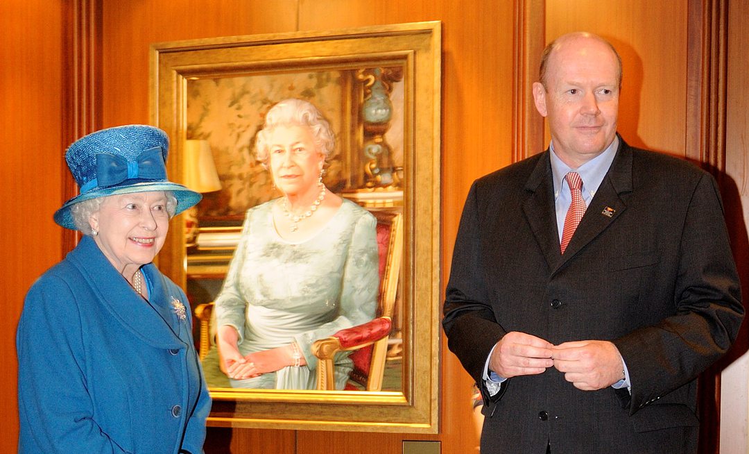 Queen Elizabeth II next to her portrait on Queen Elizabeth cruise ship in 2010.