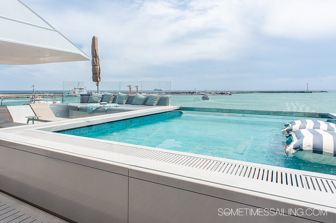 Pool on a luxury yacht, Emerald Azzurra cruise ship, with the ocean in the background.