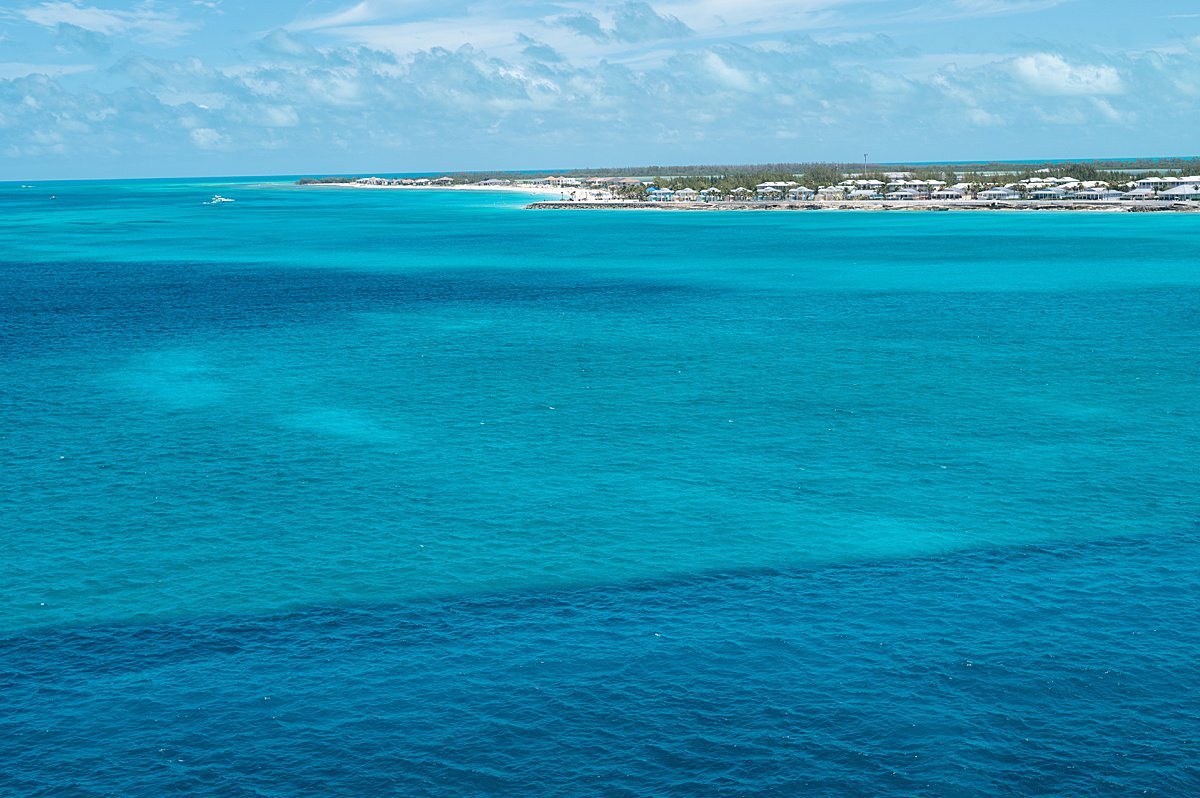 Turquoise ocean with an island in the distance, seen during a Southern Caribbean cruise.