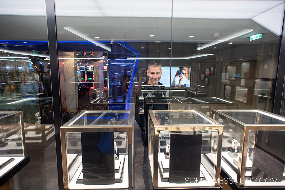 Man shopping display cases for a watch on a cruise ship.