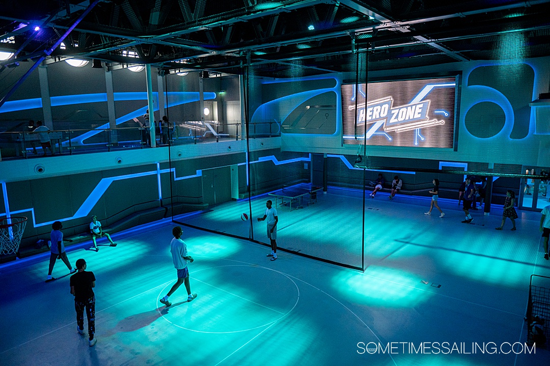 Disney ships ranked with a photos of the Hero Zone with blue lights on the interior sports courts.