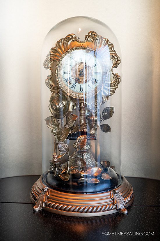 Intricate clock under a glass cloche at Disney Wish restaurant, Palo.