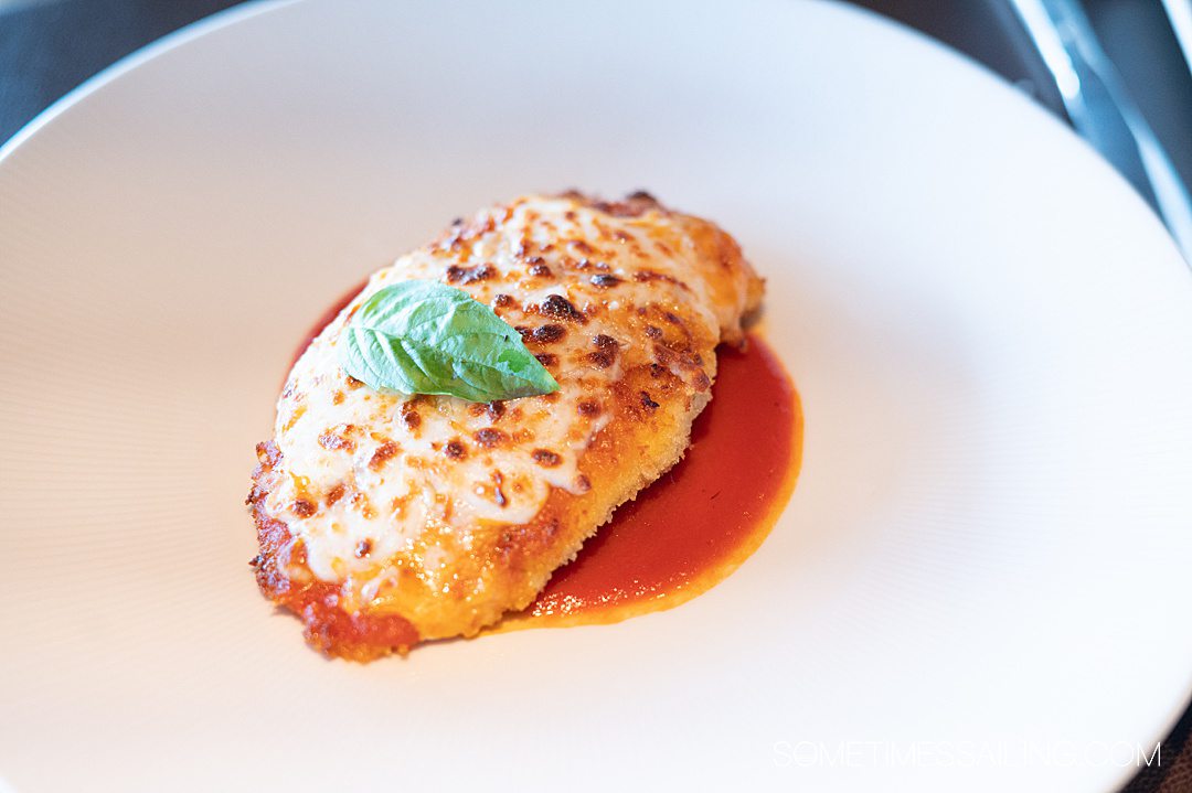 Cheese-covered piece of chicken Parmesan at Palo restaurant on Disney Wish.