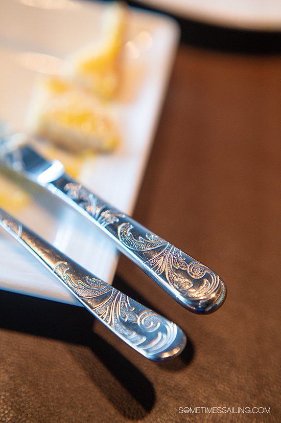 Close up detail of the swirled design on a silver knife and fork at Palo restaurant on Disney Cruise Line.