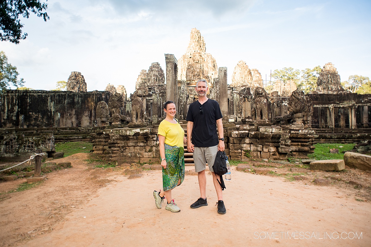 Sacred temple part of the Angkor Wat complex in Cambodia, with a couple in front.