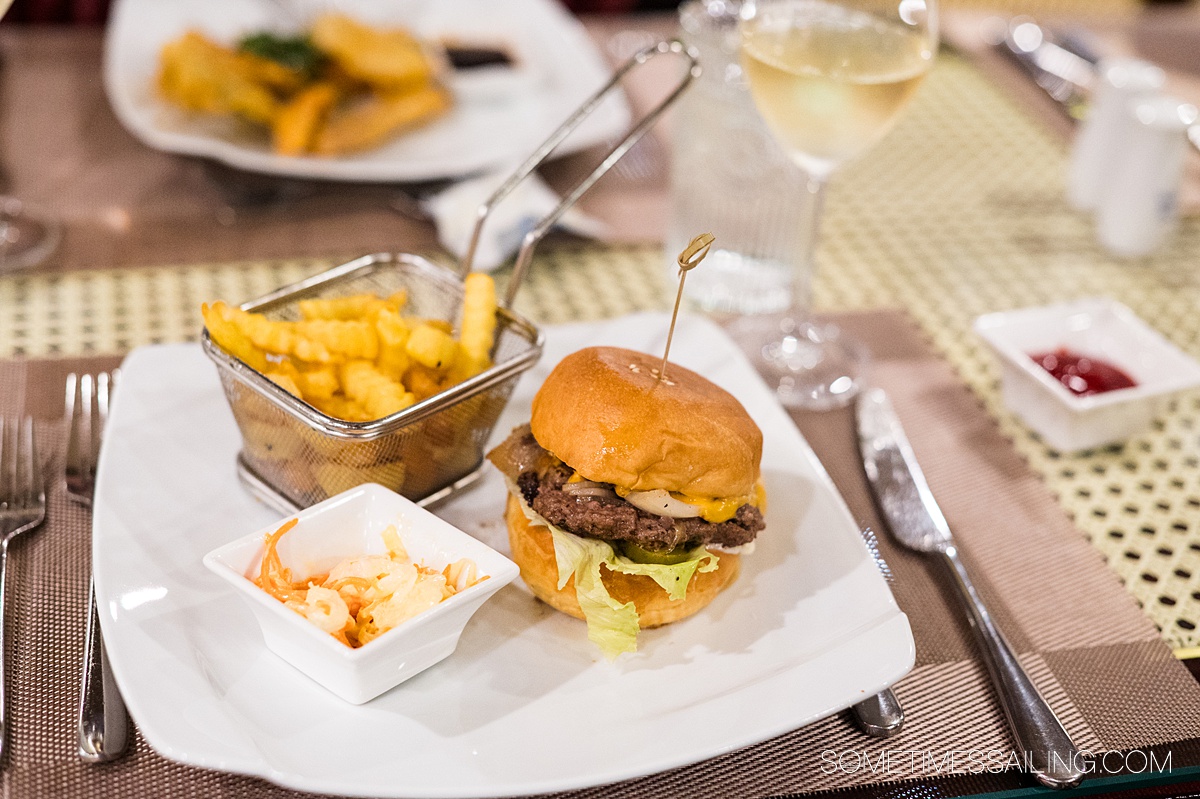 Cheeseburger and French fries on a plate during a river cruise in Southeast Asia.
