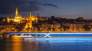 Celebrity Cruises slow shutter lights image on the Danube River in Budapest, with a signature "X" sailing by.