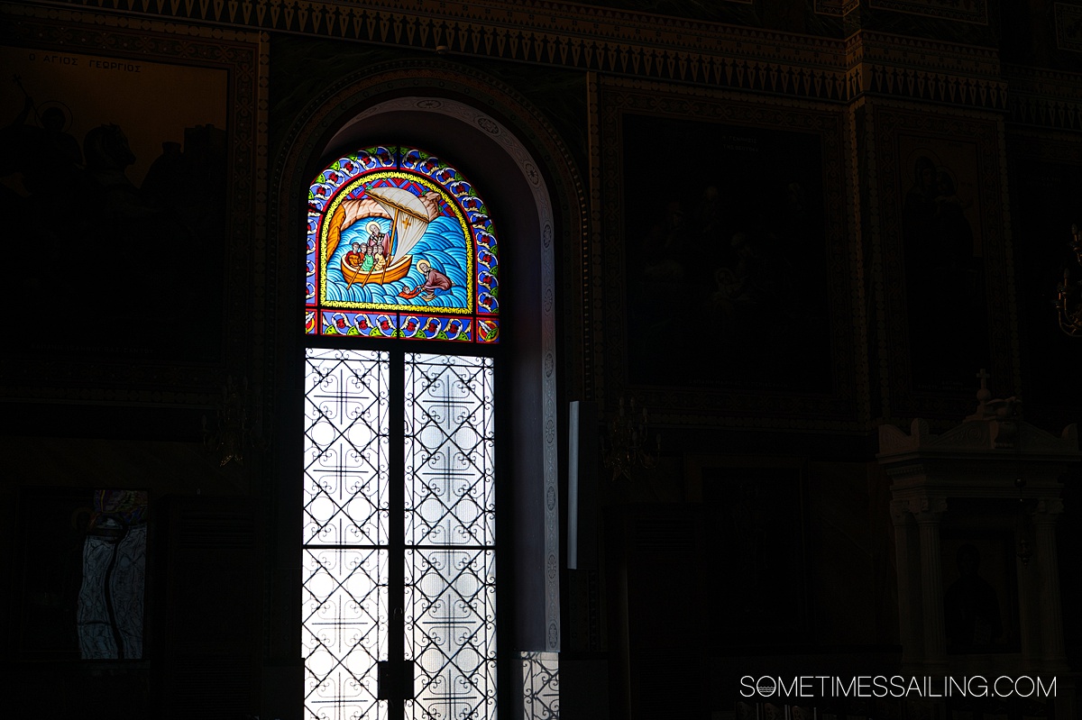 Stained glass window with a sailboat in a church in Piraeus, Greece.