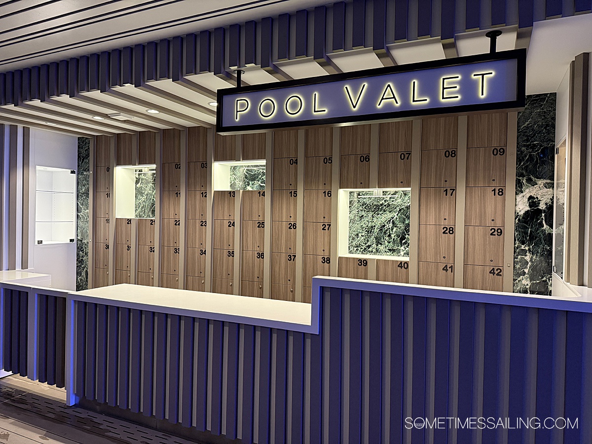 Pool Valet area with a blue and white counter and lockers behind it on Celebrity Xcel.