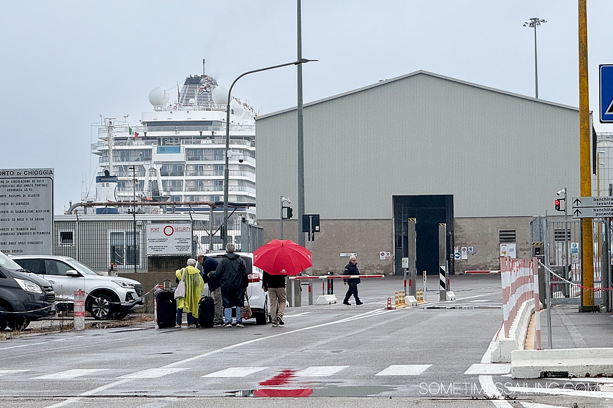 Cruise ship in the distance and a security gate in an industrial area to get to the Port of Chioggia.