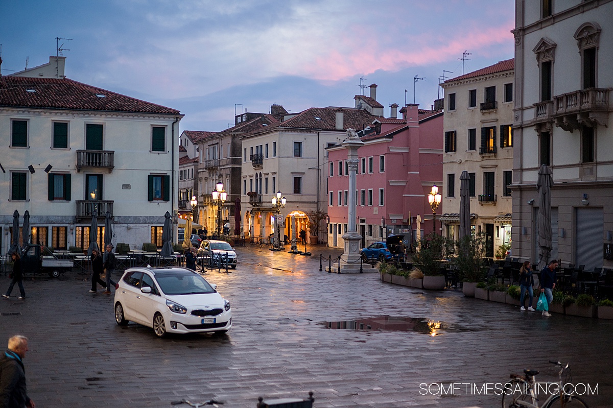 Dusk falls on downtown Chioggia, as seen from the water.