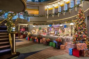 Christmas presents, garland, and gingerbread houses lined up on a cruise ship.