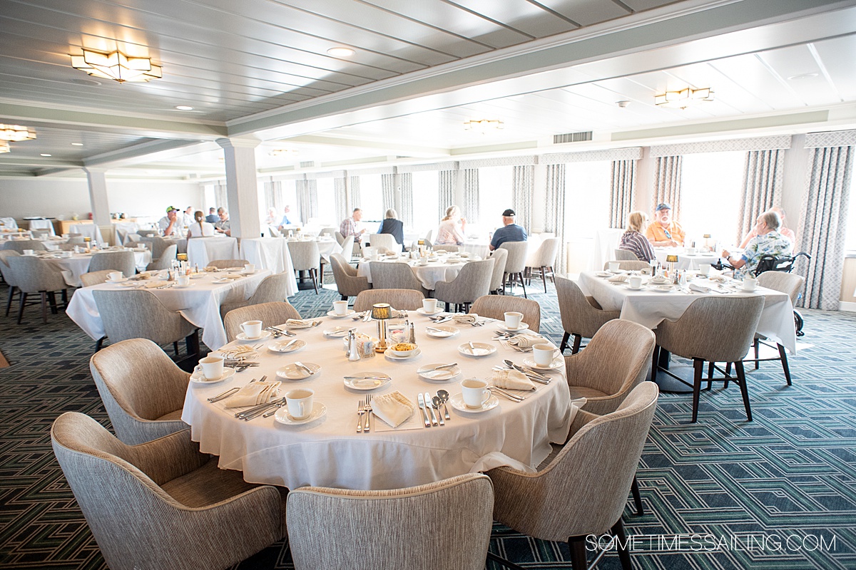 Round table with a white tablecloth in the main dining room or restaurant on American Cruise Lines.