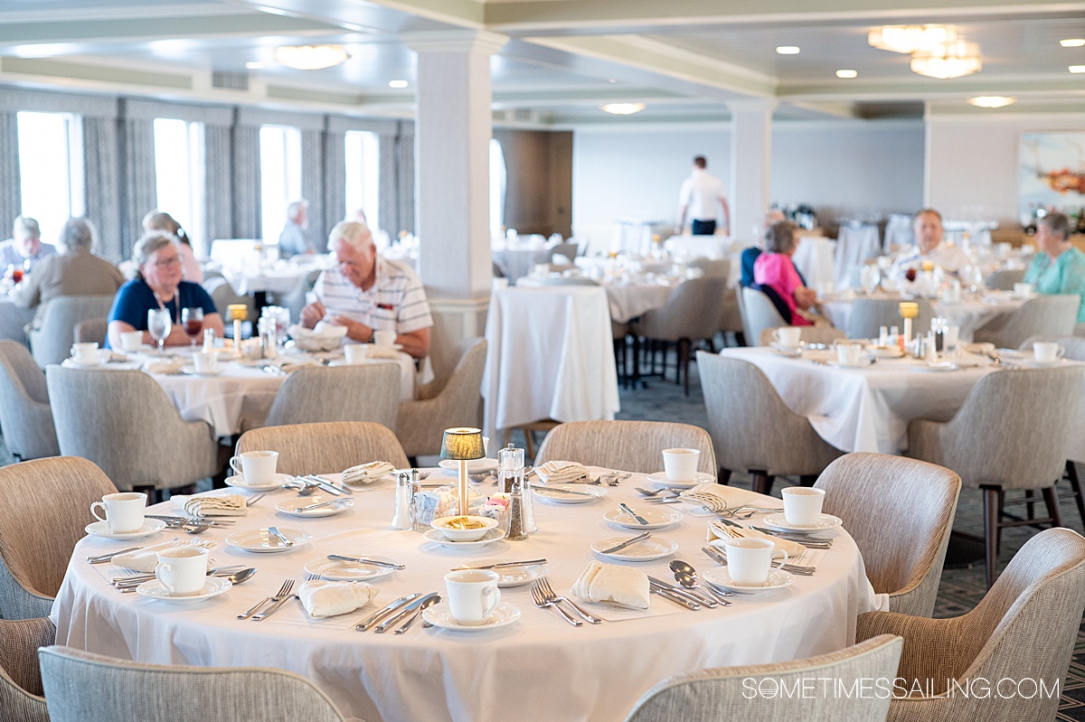 Round table with a white tablecloth in the main dining room or restaurant on American Cruise Lines.