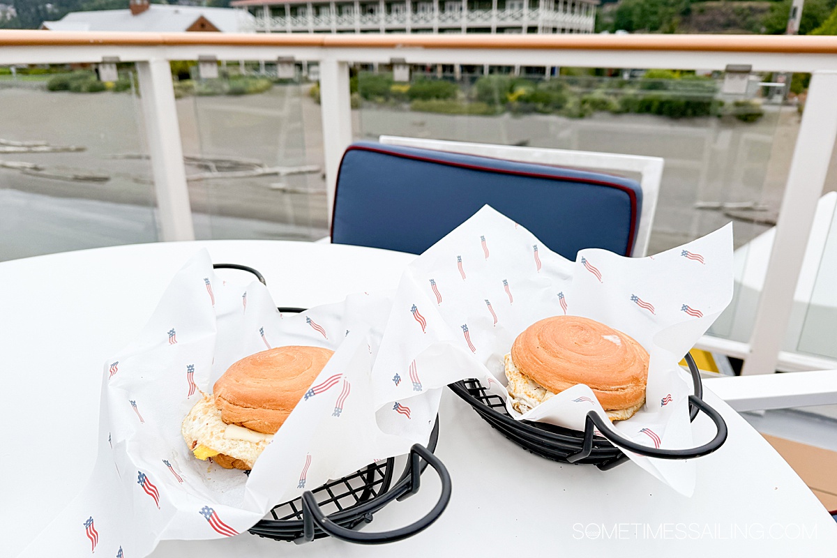 Two breakfast sandwiches in serving baskets on a table on American Cruise Lines.
