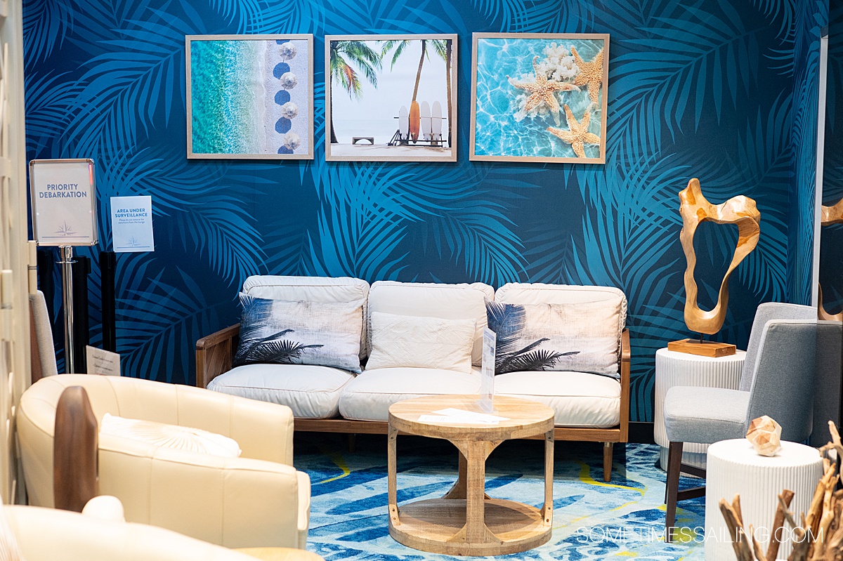 Couch and art on blue-wallpapered walls at the Concierge lounge at Margaritaville at Sea Islander.