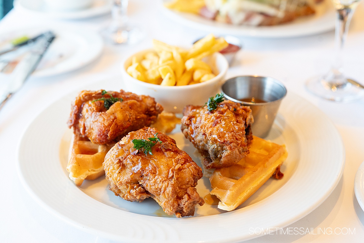 Plate of fried chicken on top of waffles.