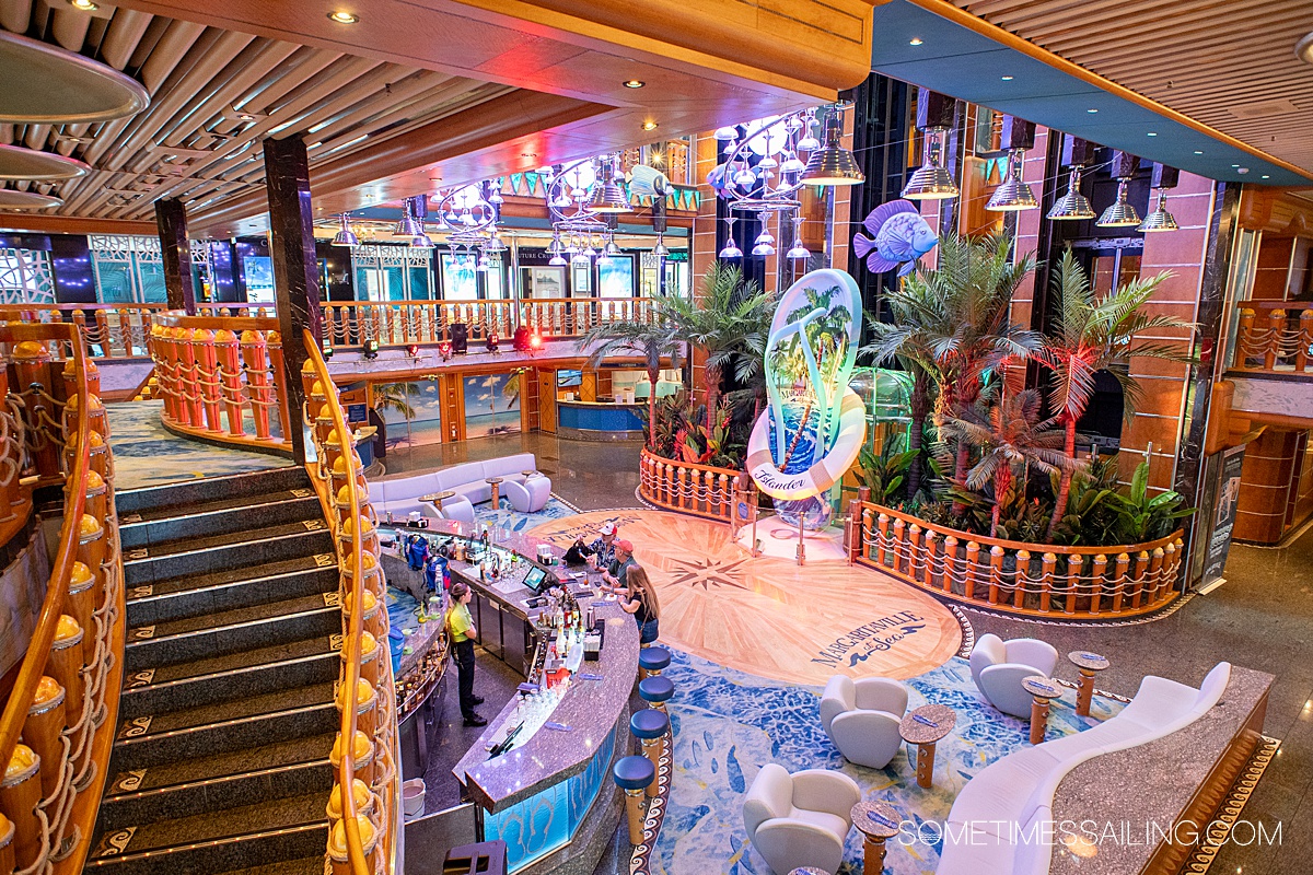 Interior of a cruise ship called Margaritaville at Sea with an oversized flip flop icon sculpture, greenery.