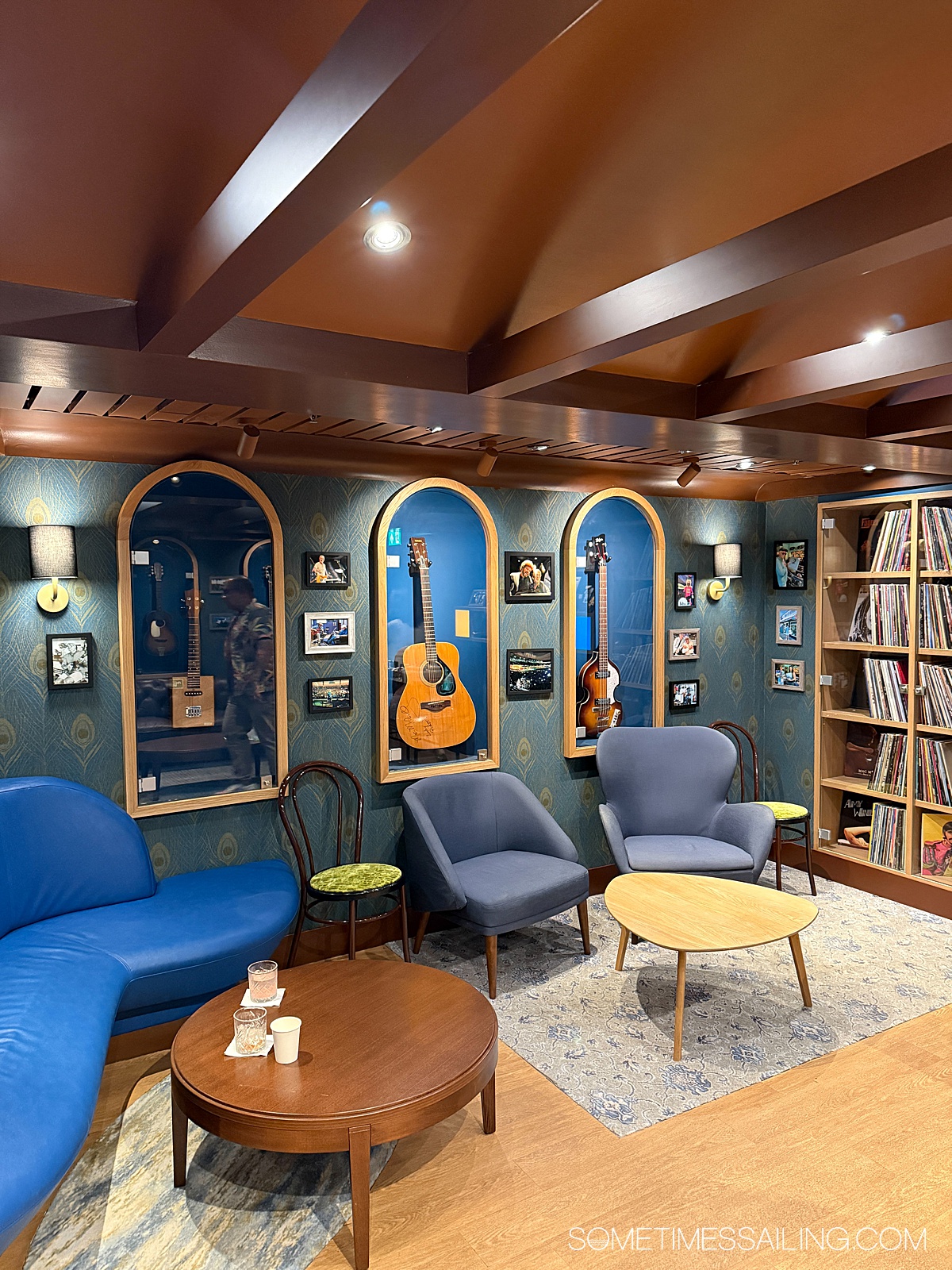 Speakeasy experience with musician memorabilia on the walls with blue-colored interior design.