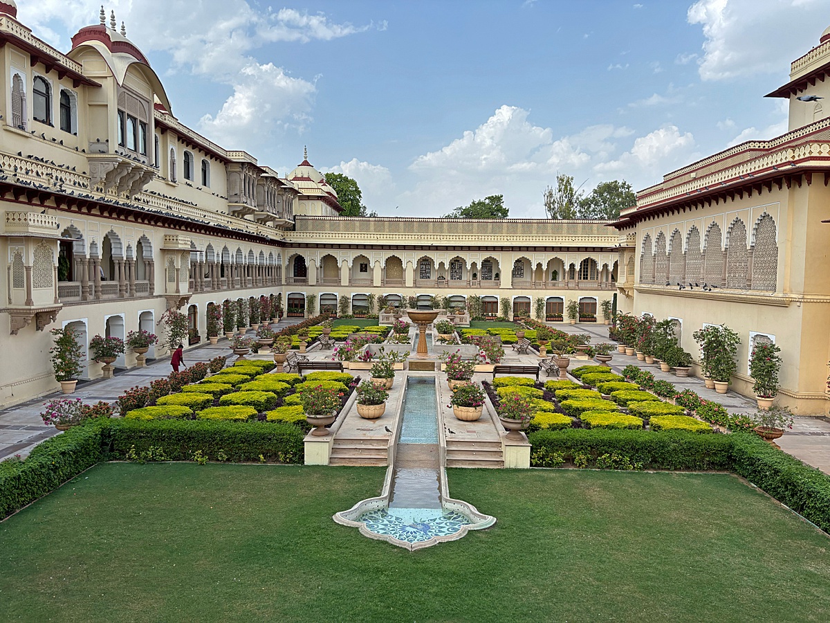 Jaipur Rampbagh Palace with a view of the interior courtyard fountain and gardens.