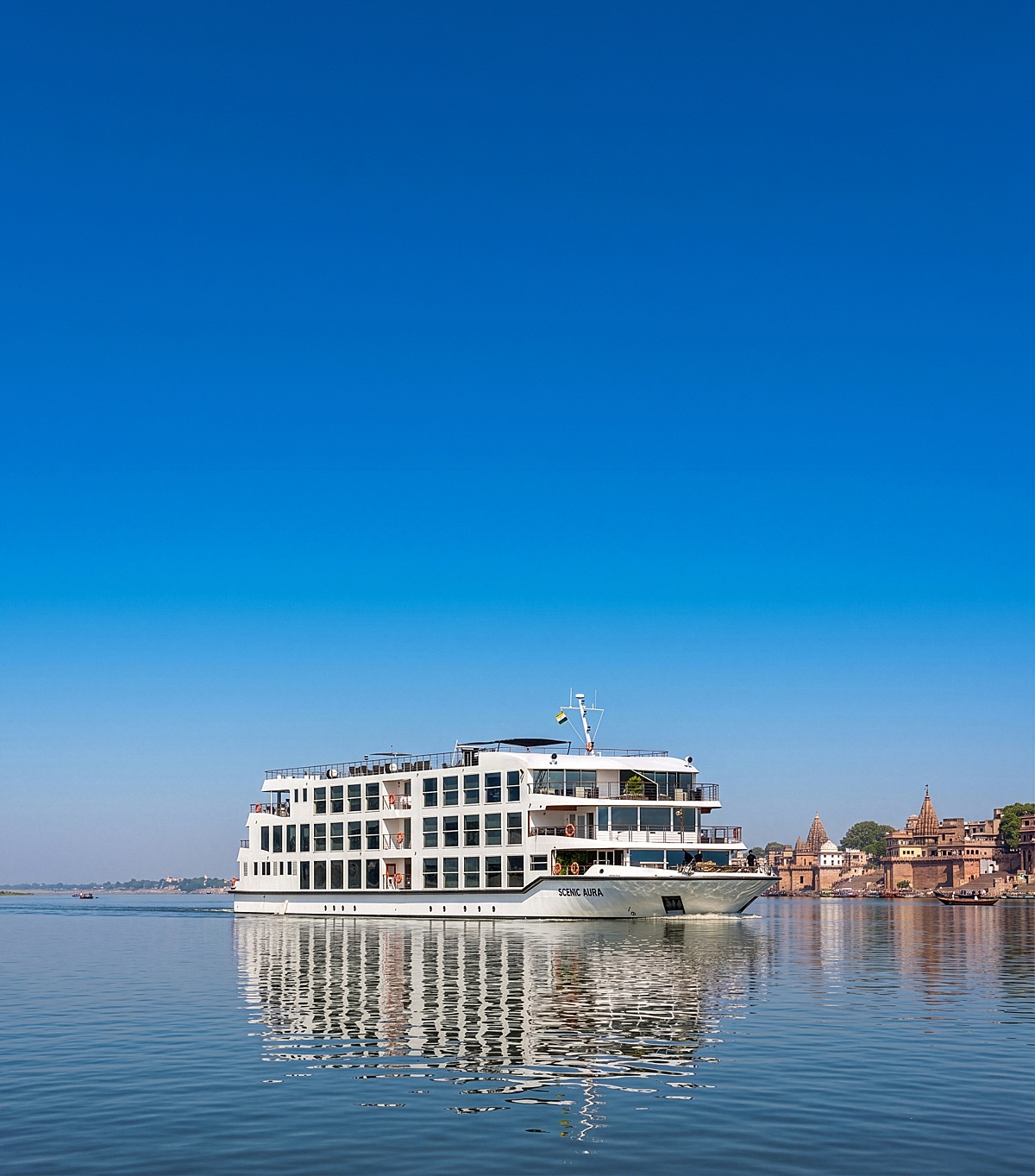 Exterior view of a river cruise ship with a top deck on the Lower Ganges River in India.