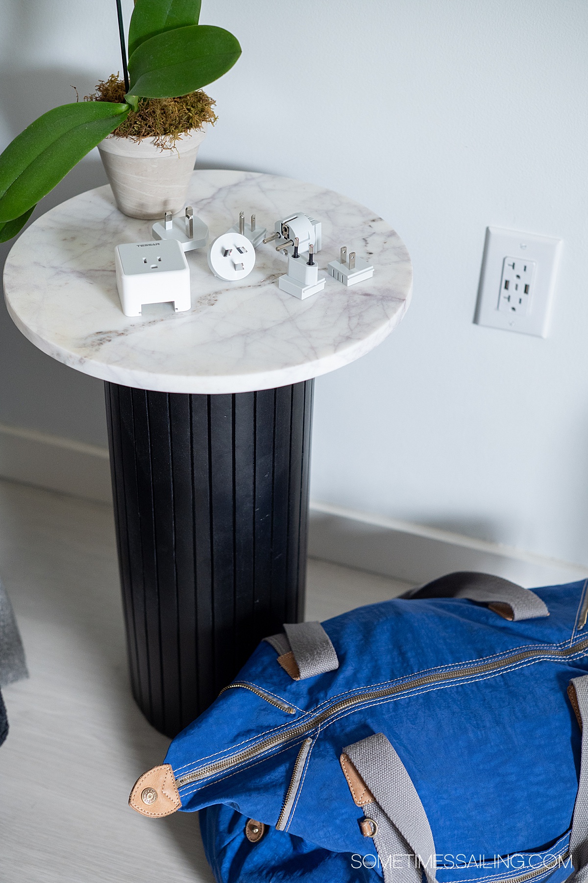 Small table and bag on the floor next to it.