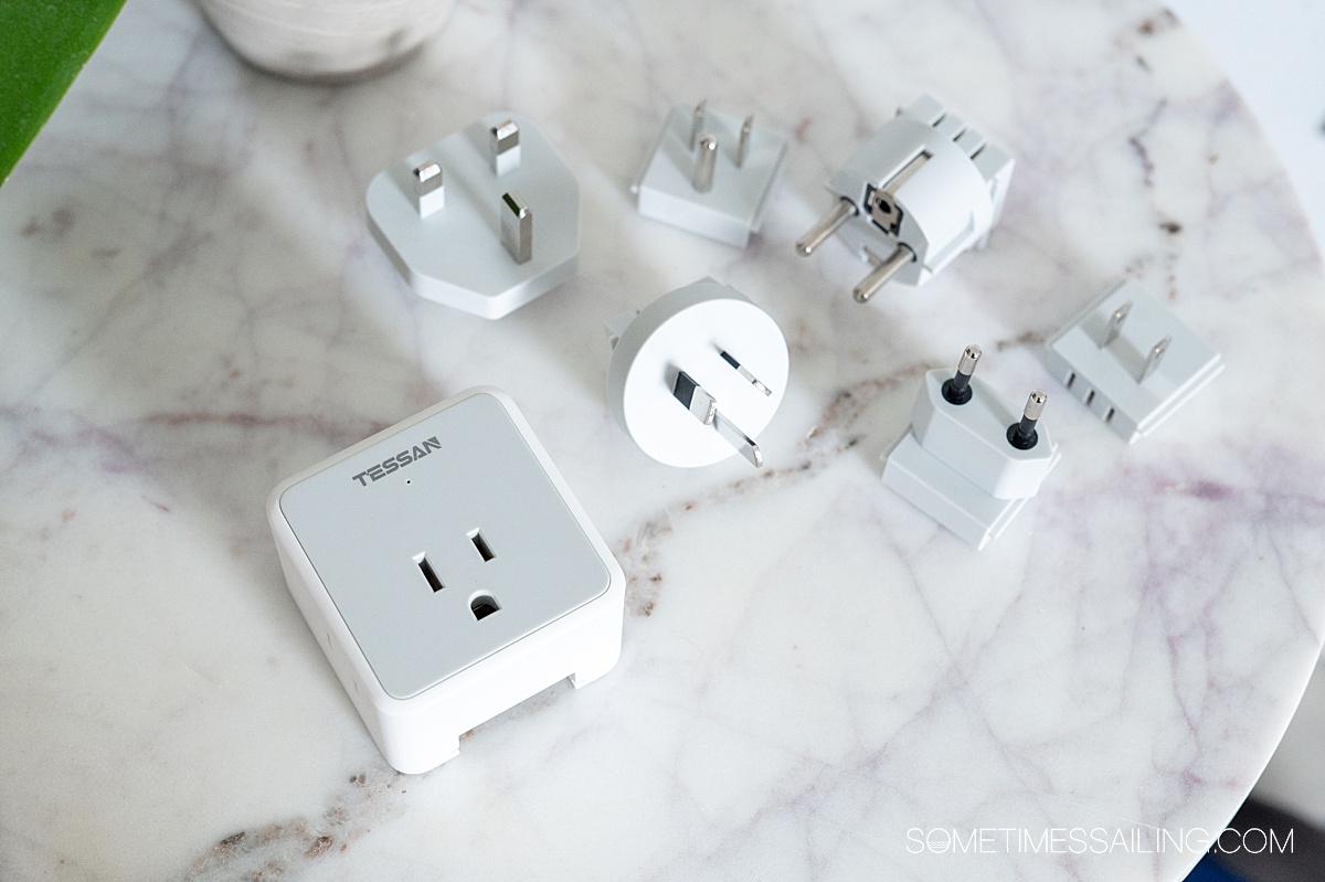 Marble table top with an electronic travel adapter with interchangeable pieces.