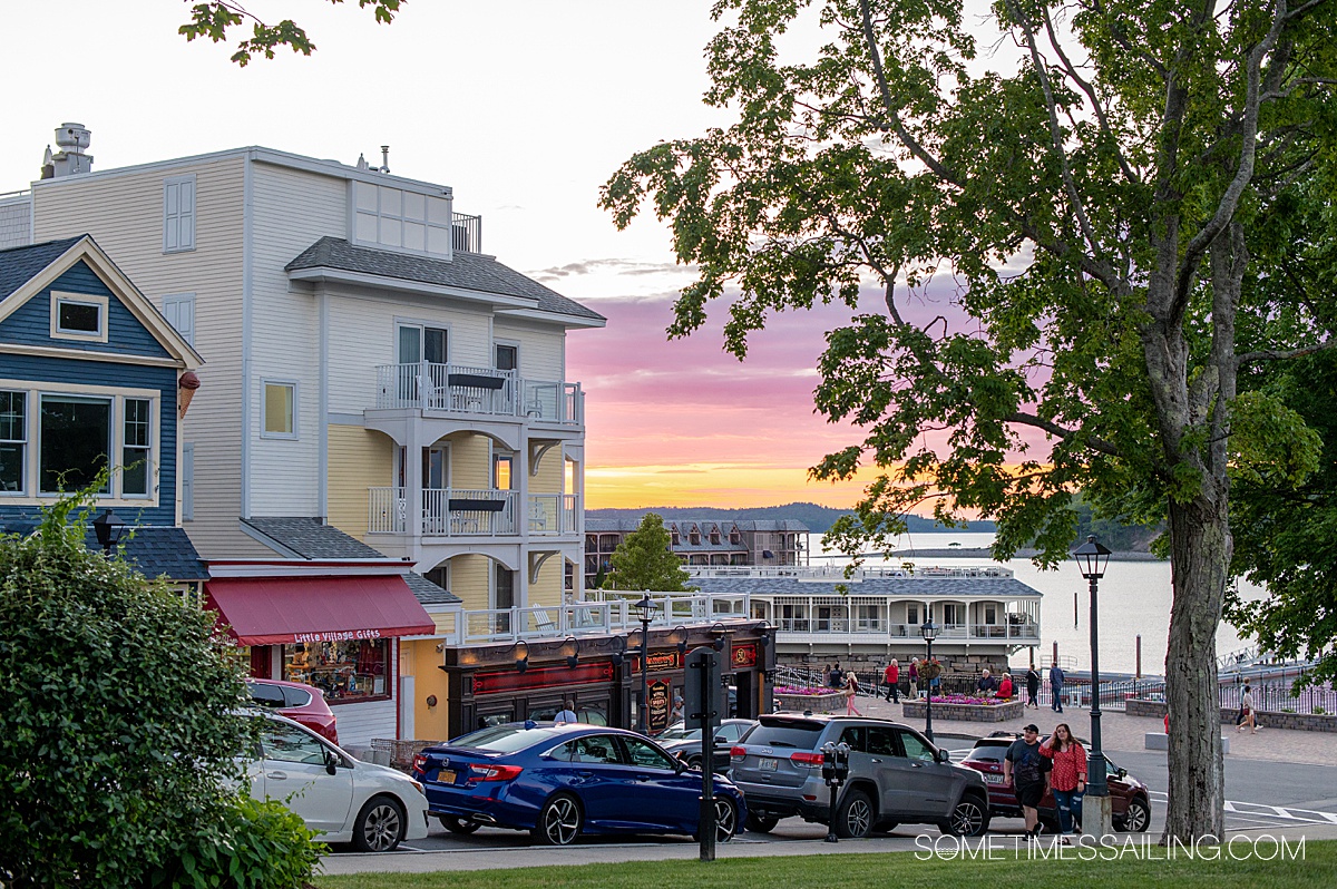 Purple, pink and orange sunset behind a building in downtown Bar Harbor, Maine.