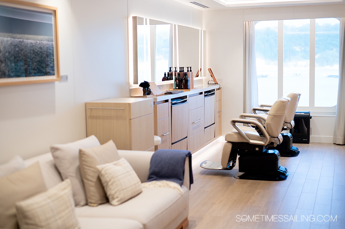 Salon chairs in a row with a window overlooking the ocean in the distance.
